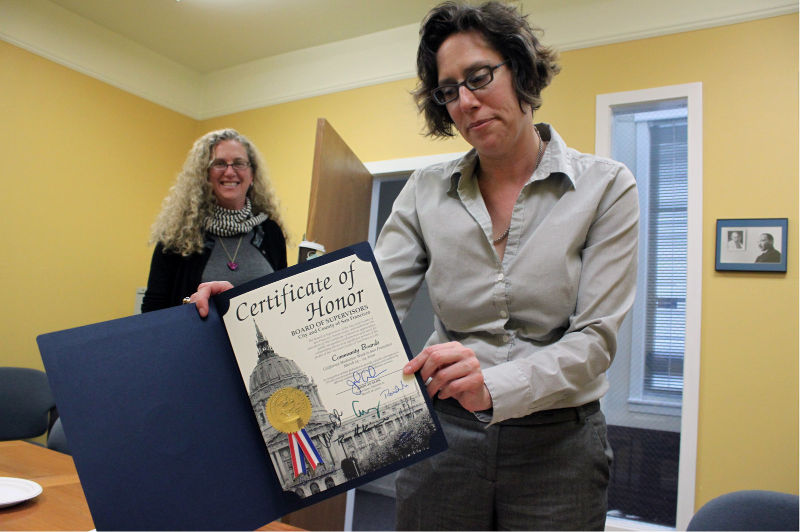 Darlene Weide shows off a certificate from the Board of Supervisors.