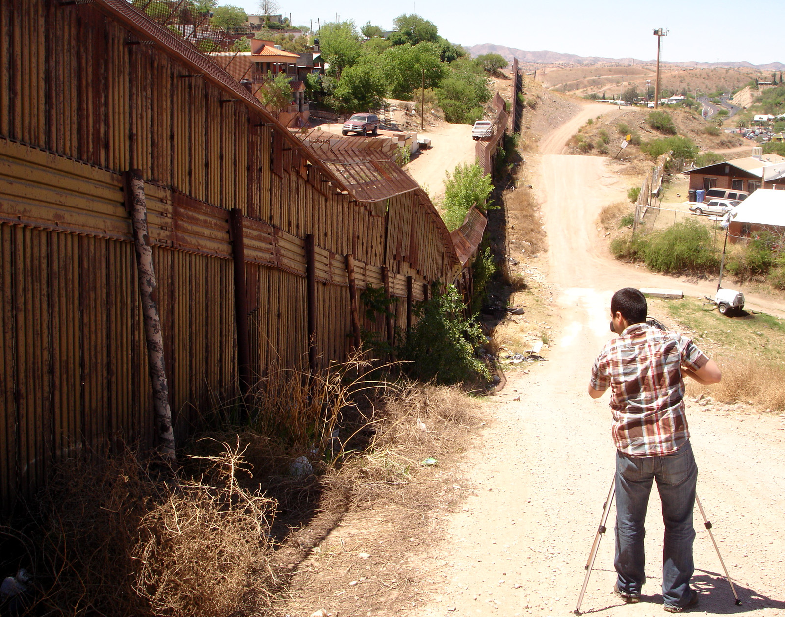 Director Ricardo Martinez filming the fence on the US and Mexican border