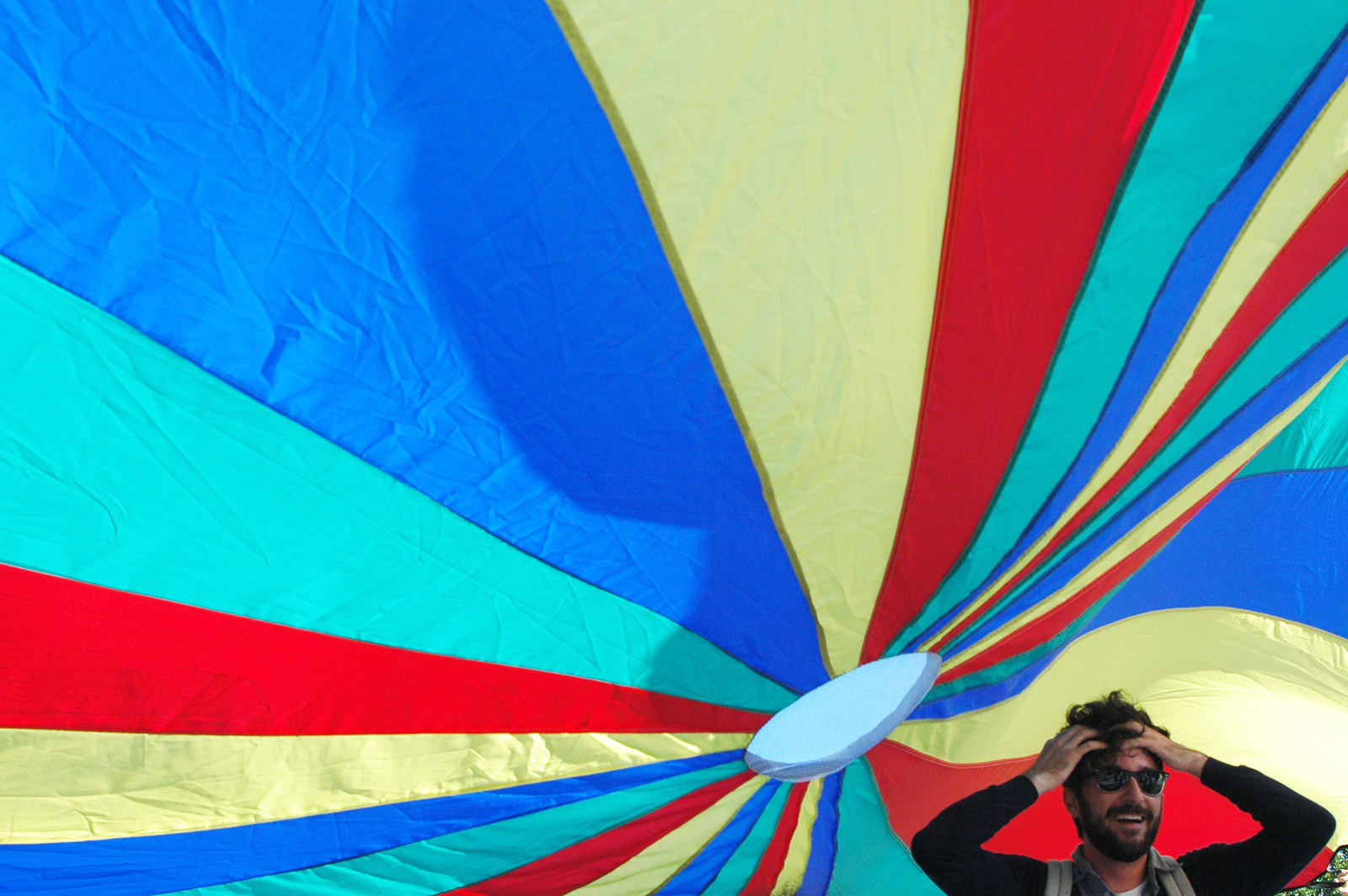 Photo shows man under a parachute.