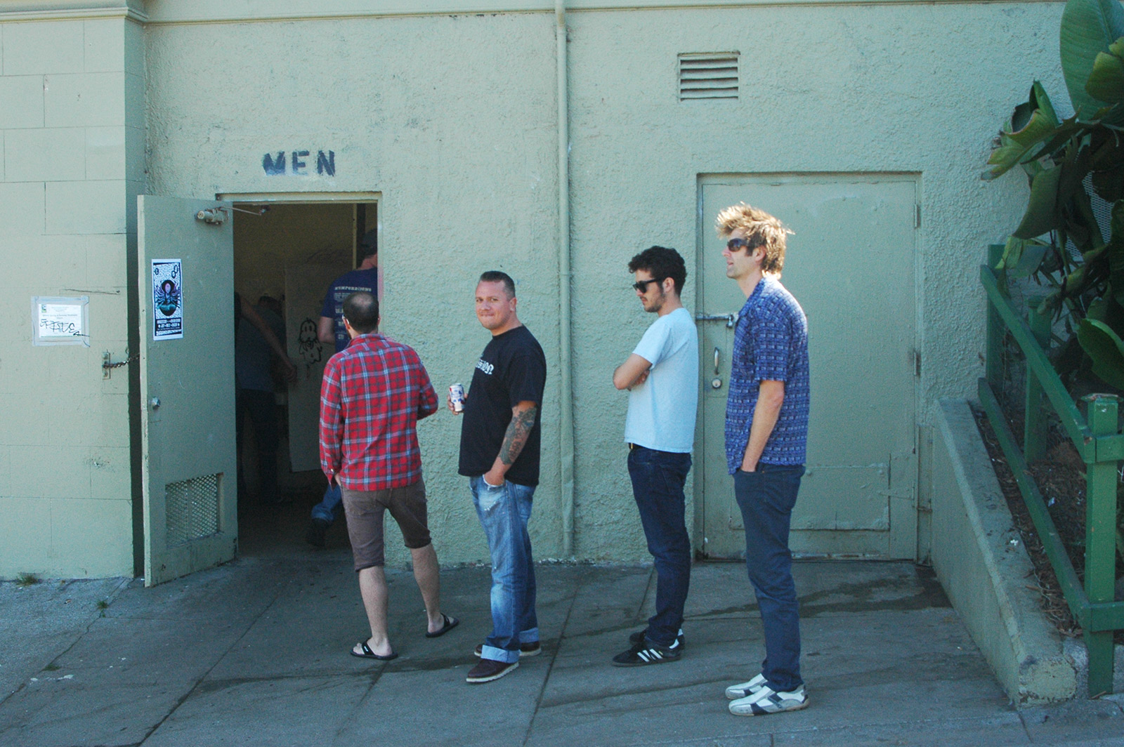 Image shows men standing in line.