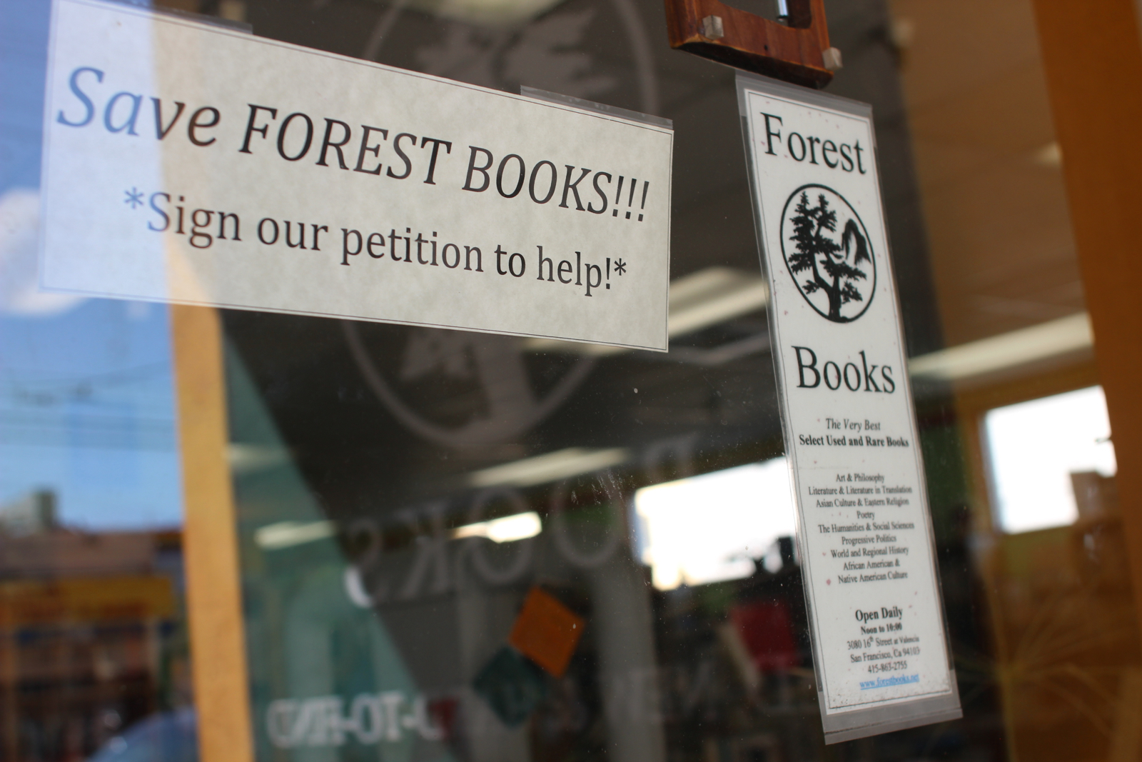 signs on the door at Forest Books