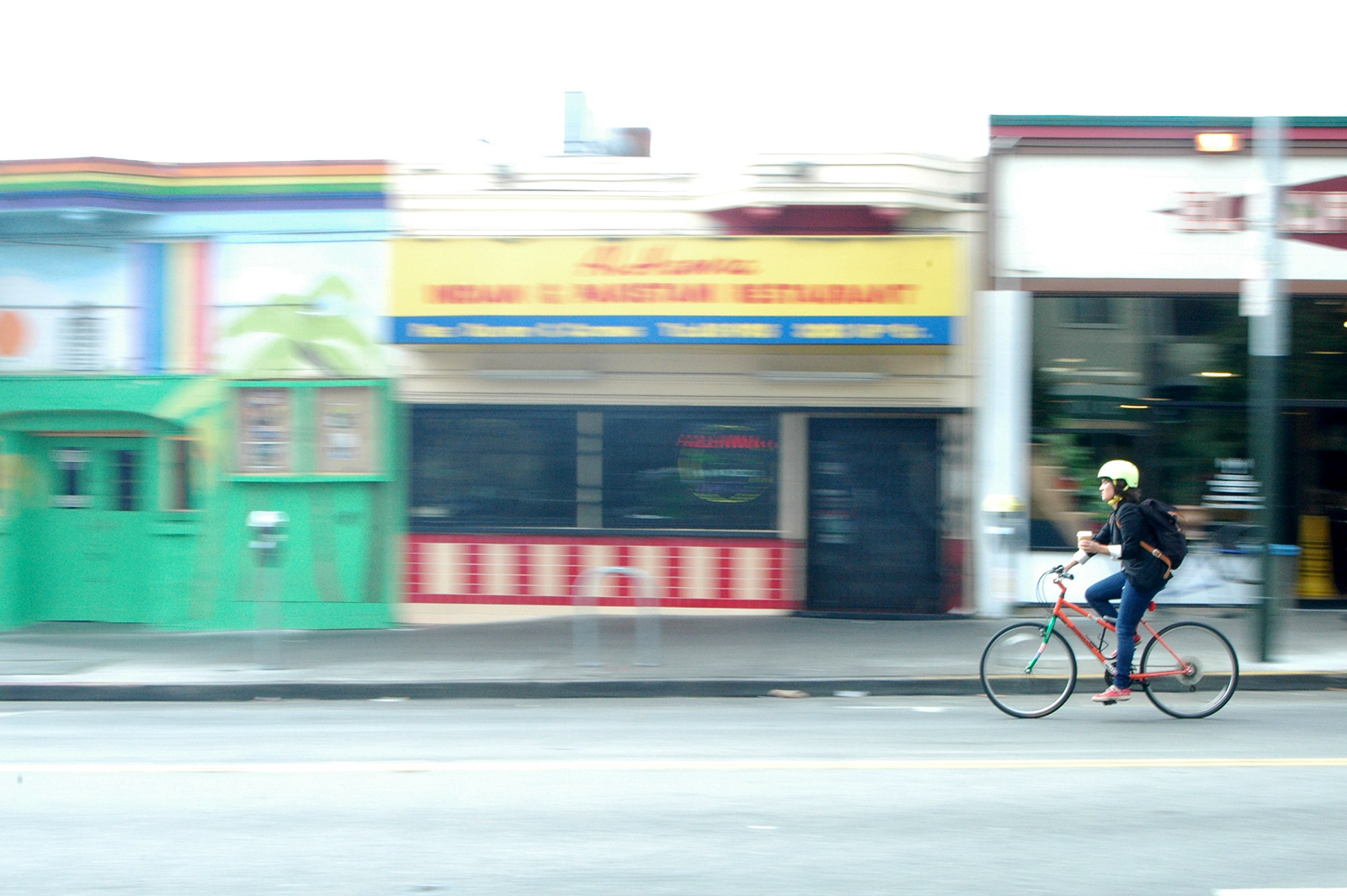 Image shows a woman on a bicycle.