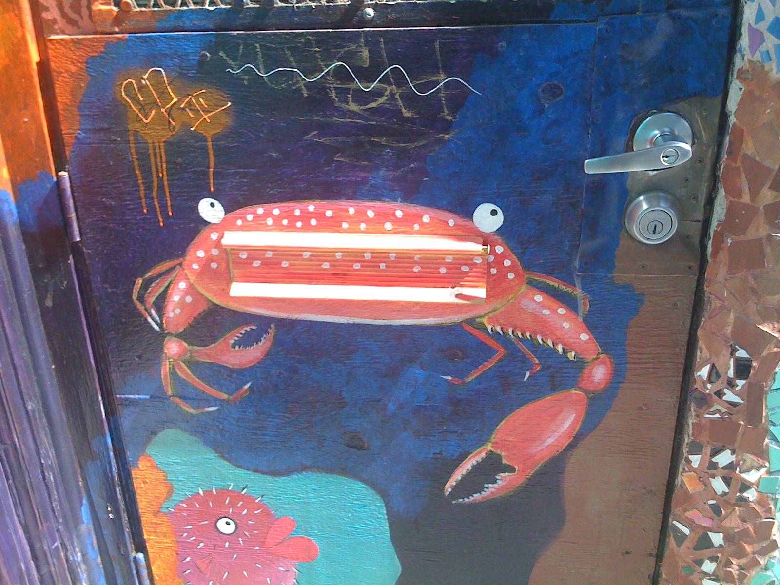 crab painting as a mail slit in a door