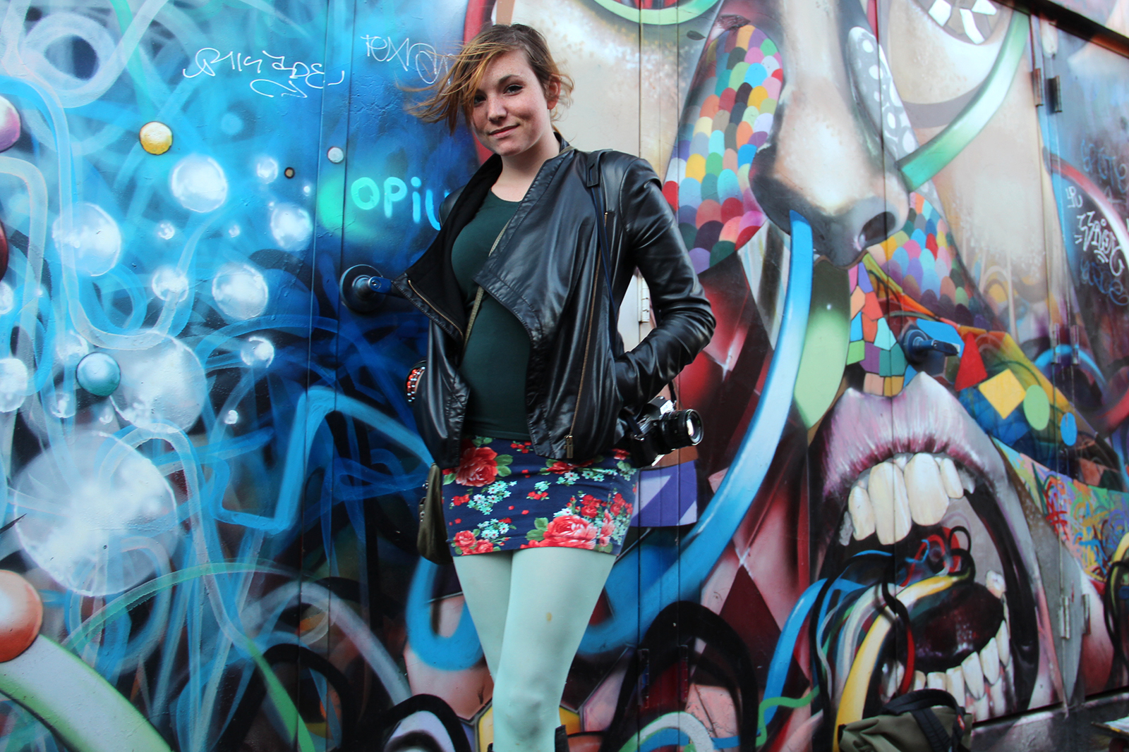 Nichole Albright keeps it cool in mint green tights, a floral skirt and a structured leather jacket.