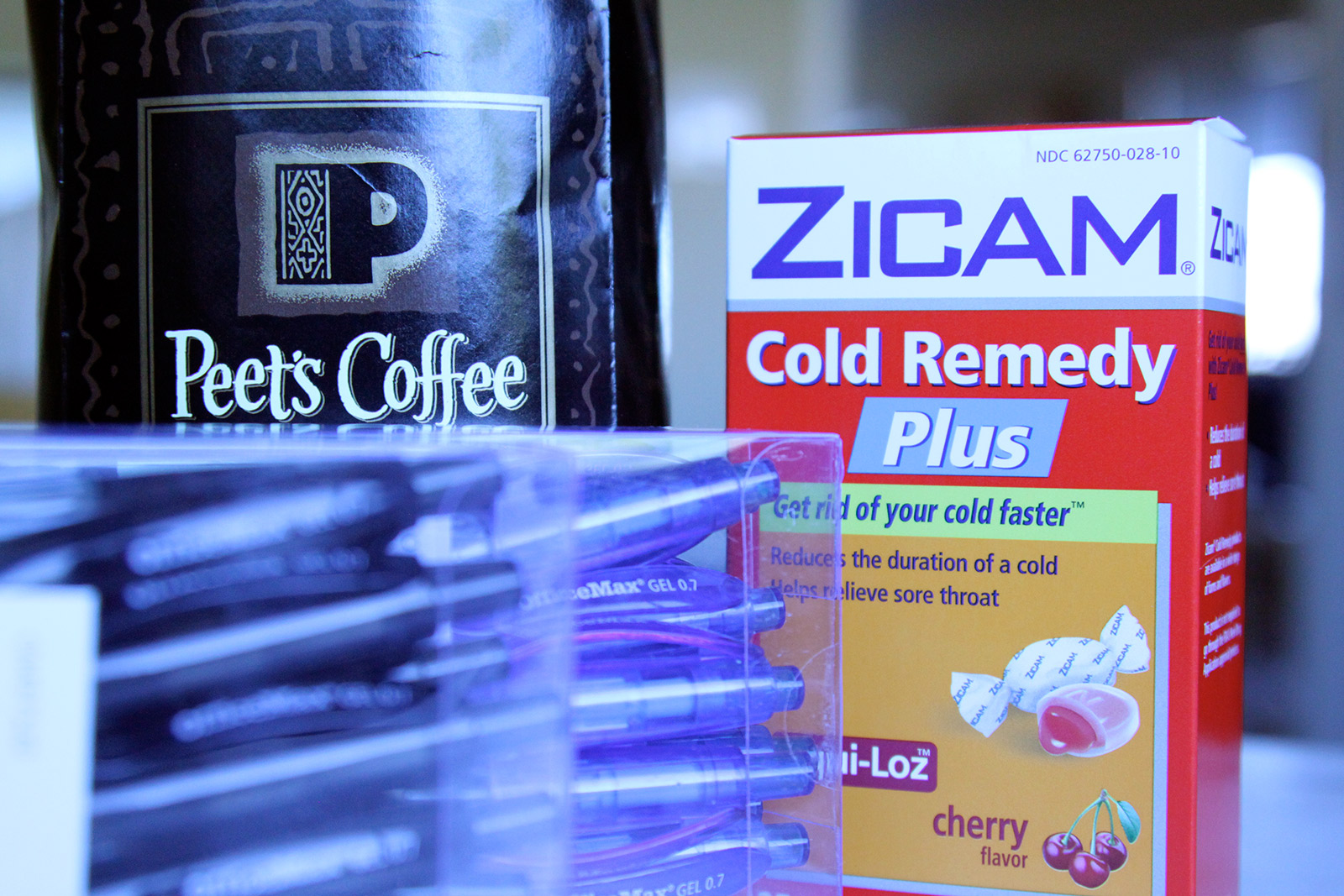 Image shows a bag of coffee, cold medicine, and pens
