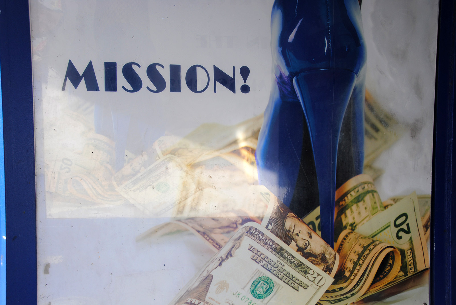 Image shows a blue stilleto standing on money