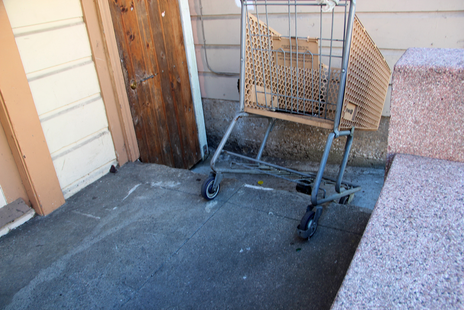 The back of a yellow shopping cart.