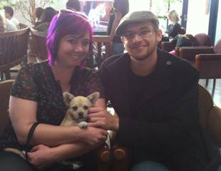 Image shows dog with her owners.