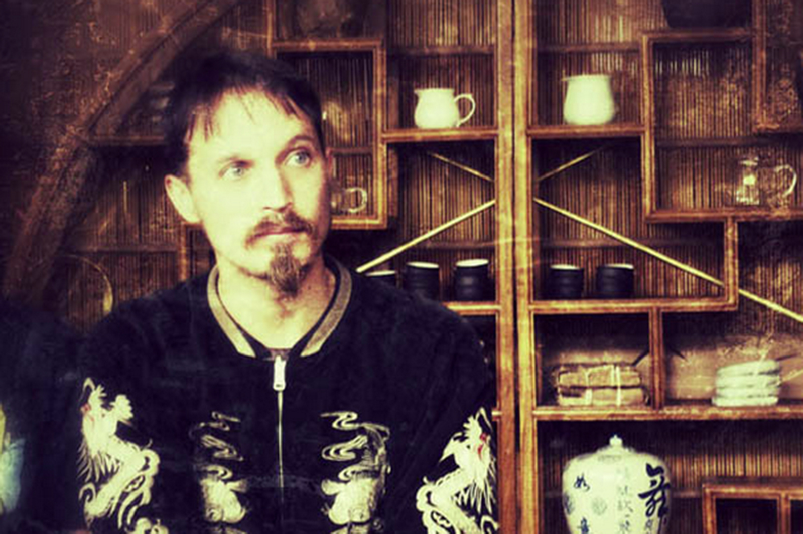 A man stands in front of some tea.