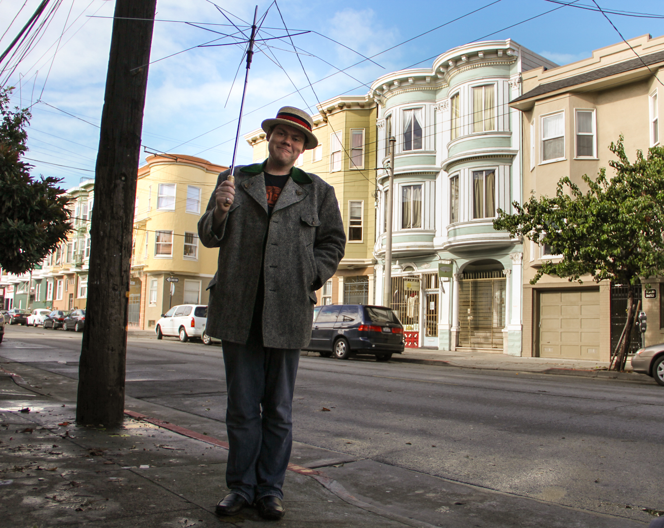 man holding broken umbrella