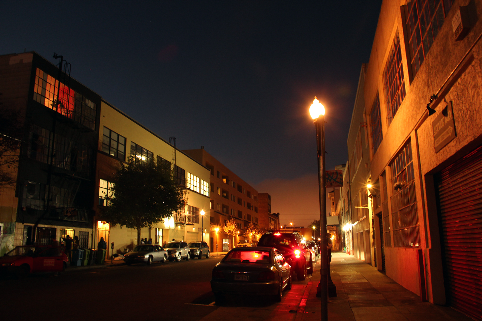 Capp Street between 16th and 17th, dark street with people and streetlamp