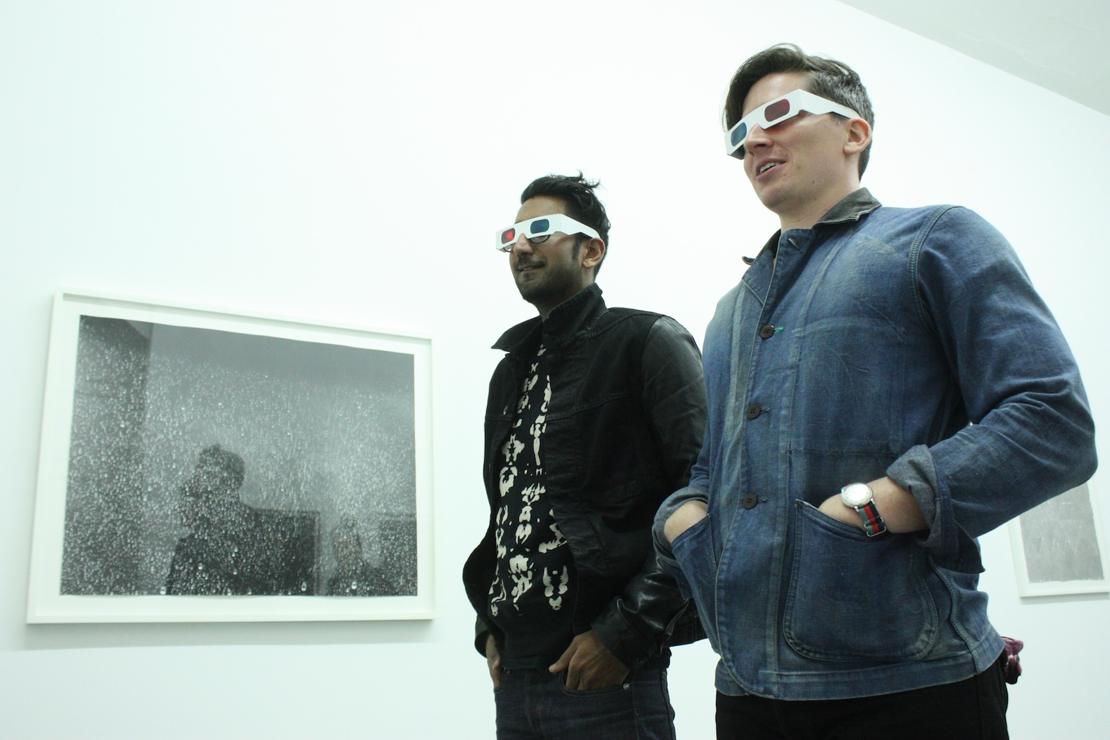 Two visitors wearing 3D glasses.