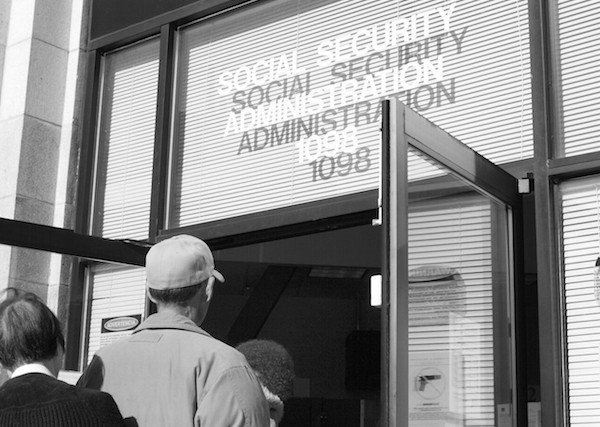 A line of some 30 people finally files into the Social Security Administration building on Valencia at 9 a.m.