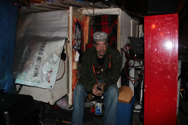 Eddie "Tennessee" Tate sitting in his shelter on Division Street in February 2016, where he said he'll wait until the last minute to move.