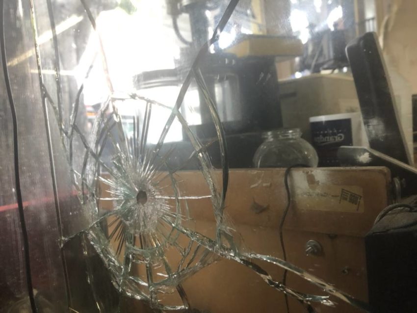 A shooting left holes in this window.