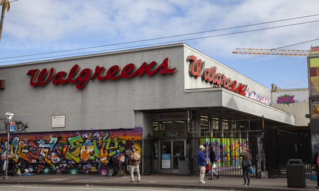 A building with graffiti on the side of it. Site for future tiny homes.