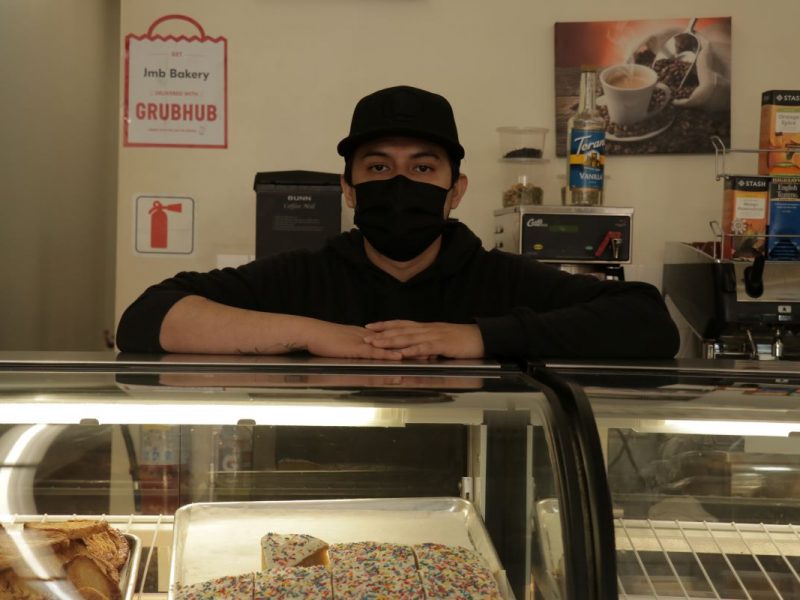 Eduardo Daniel Mooyah stands behind the counter at JMB Bakery on 16th Street. Photo by Juan Carlos Lara.