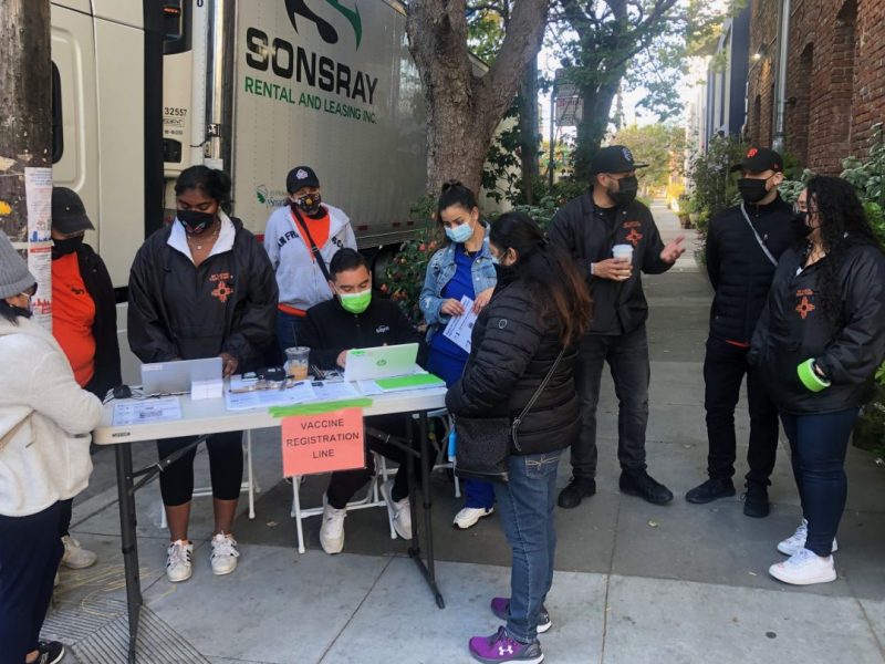 Members of the Latino Task Force at the 701 Alabama St. Food hub registering residents for the vaccine.