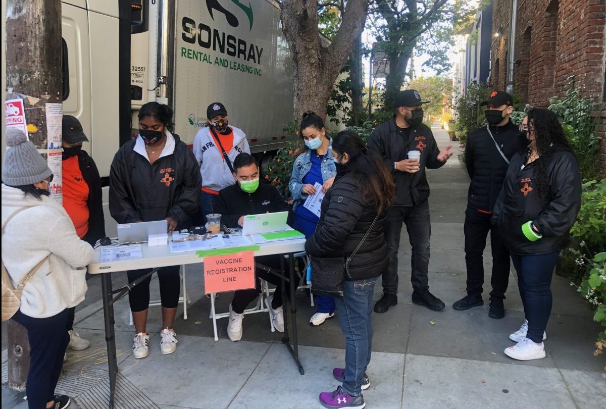 Members of the Latino Task Force at the 701 Alabama St. Food hub registering residents for the vaccine.