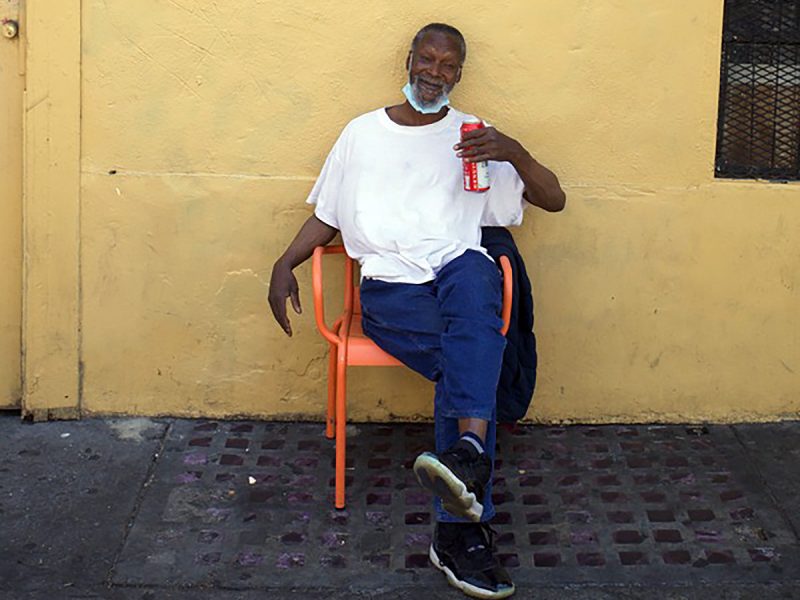 Man in an orange chair on 16th Street
