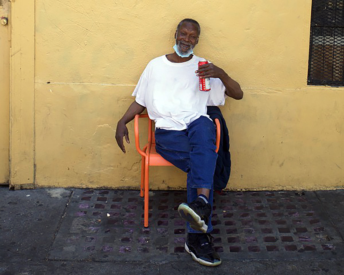 Man in an orange chair on 16th Street