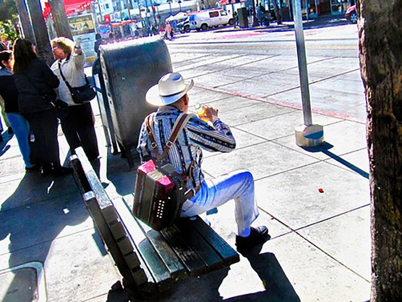Man with a guitar on Mission Street