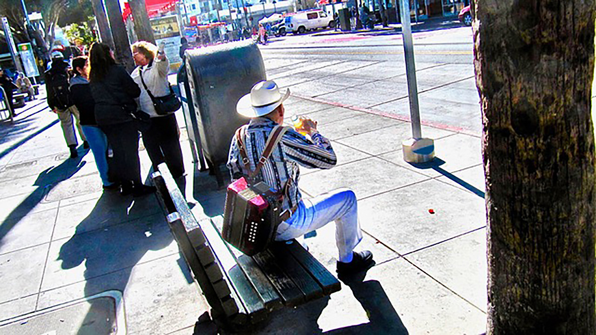 Man with a guitar on Mission Street