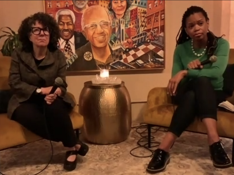 Dr. Kunins sitting in chair answering questions from audience at Manny's on Oct. 26