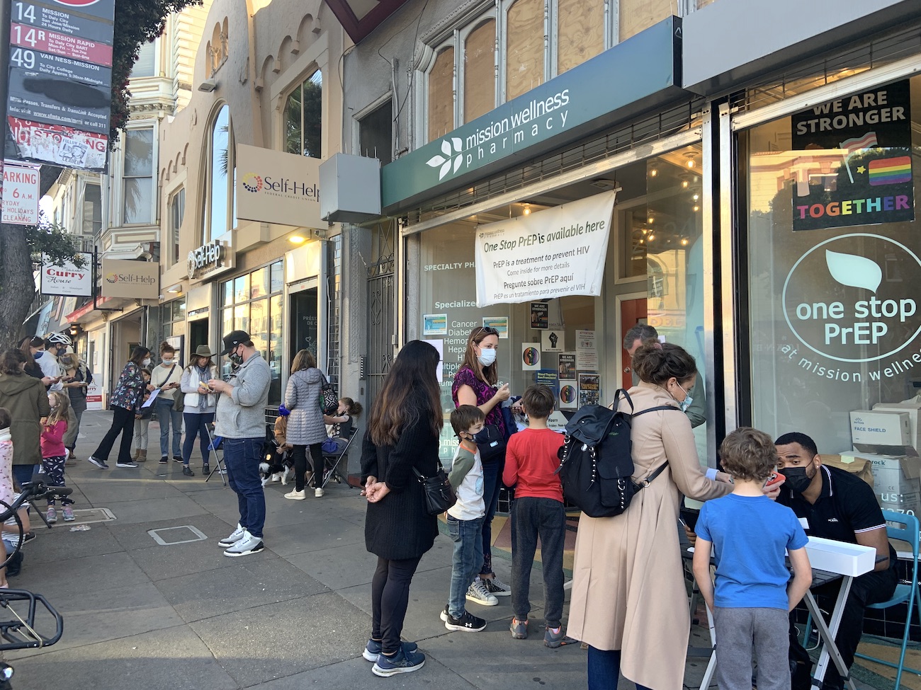 Parents and their 5-11 year old children line up outside Mission Wellness Pharmacy to receive a pediatric dose of the Pfizer Covid-19 vaccine on Nov. 4, 2021