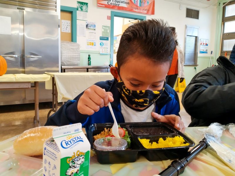 Young pupil Moses eats a Thanksgiving dinner.