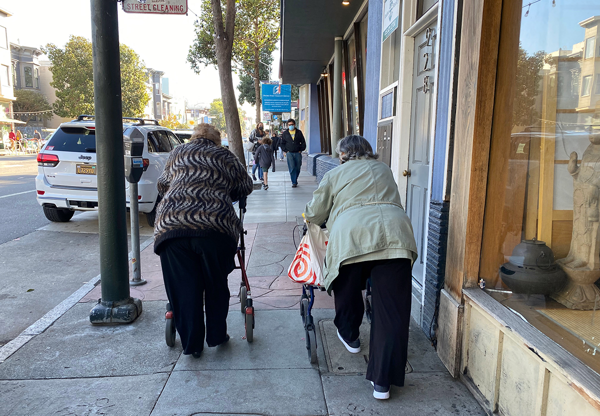 Two old friends walking on walkers. Seniors