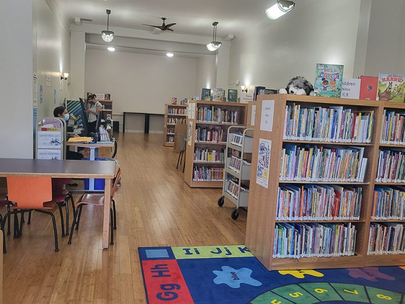 Inside the temporary library showing tables, and books.