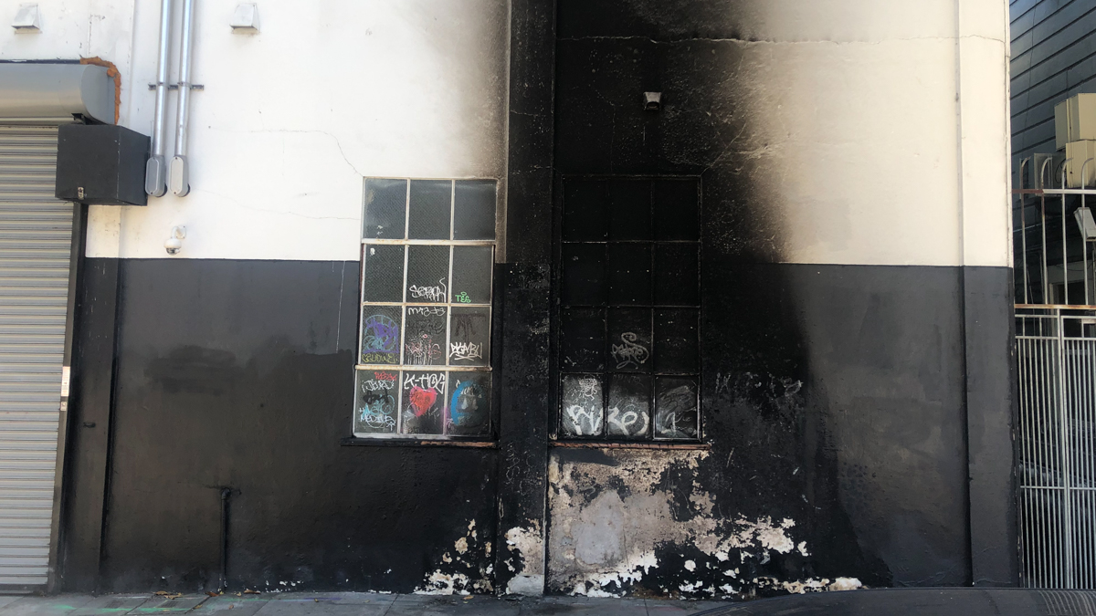 A scorched wall and sidewalk from the fire on 1417 15th Street.