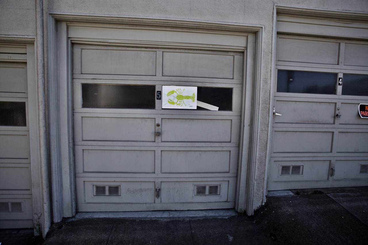 A stencil of a lobster on a garage
