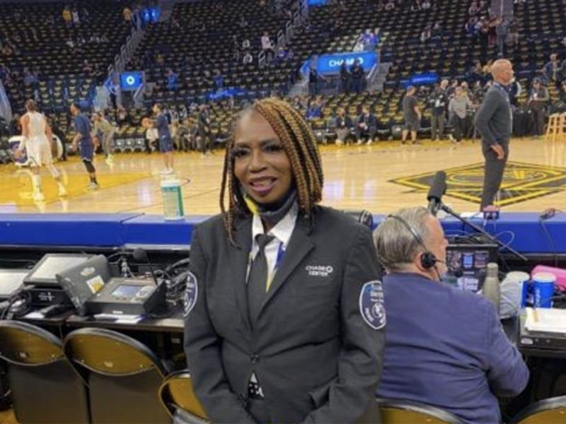 Warriors security guard poses on court.