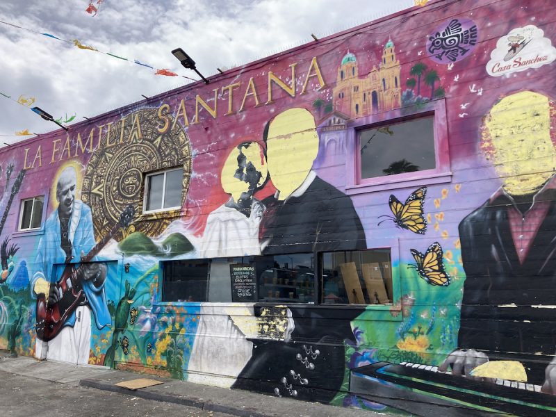 La Familia Santana mural with three faces scraped off