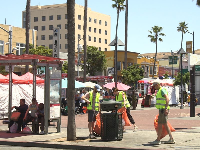 Volunteers pick up trash at 24th and Mission BART Plaza