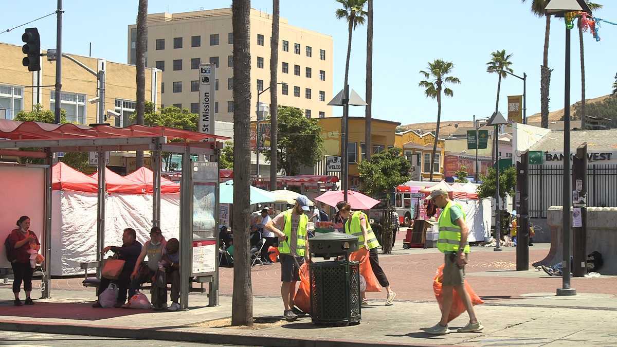 Volunteers pick up trash at 24th and Mission BART Plaza