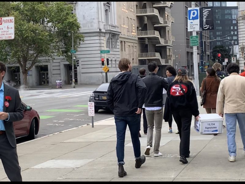 Dean Preston admires volunteers dropping off vacancy tax signatures.