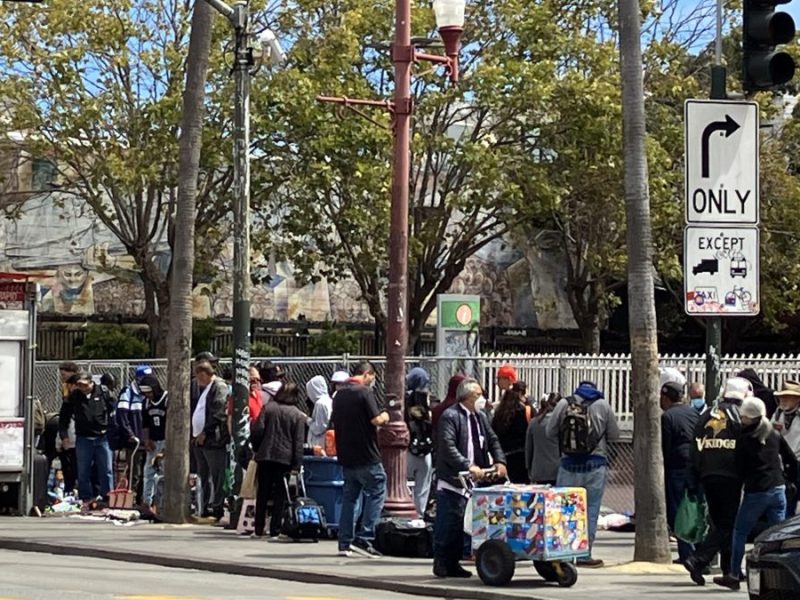 A mass of people and vendors line up at the Northeast 24th and Mission BART Plaza