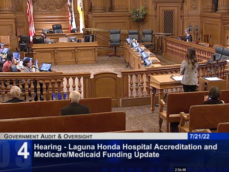 In a court room, four Supervisors sitting on the left listen to Roland Pickens presenting on the right.