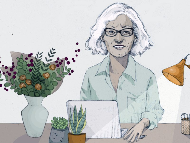 Illustration of a woman with white hair sitting at her desk with flowers