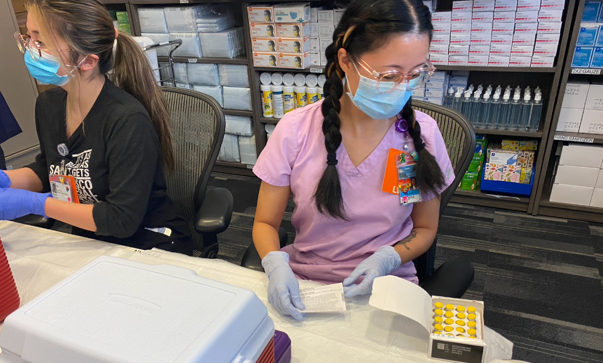A nurse opens a monkeypox vaccine kit at SF General Hospital.