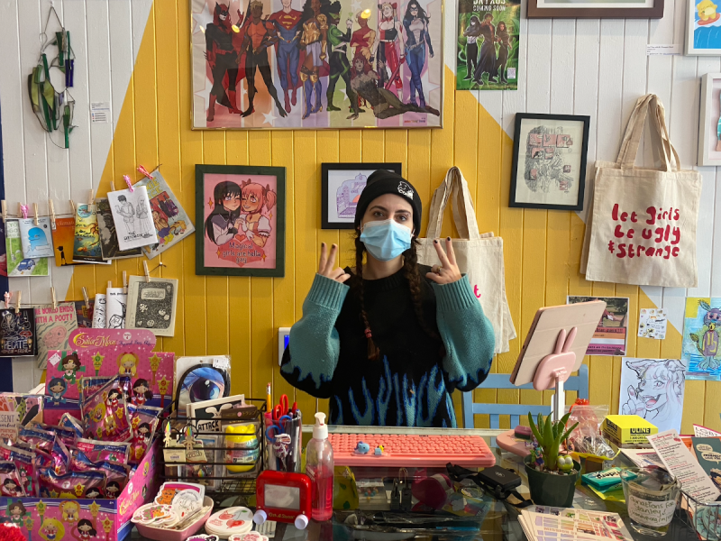 Leah Morrett stands behind the counter at her store Sour Cherry Comics.