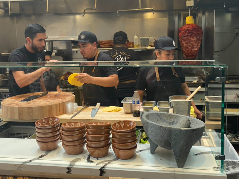 Jose Mendoza, far left, talks to his employees on opening day at "El Rey."