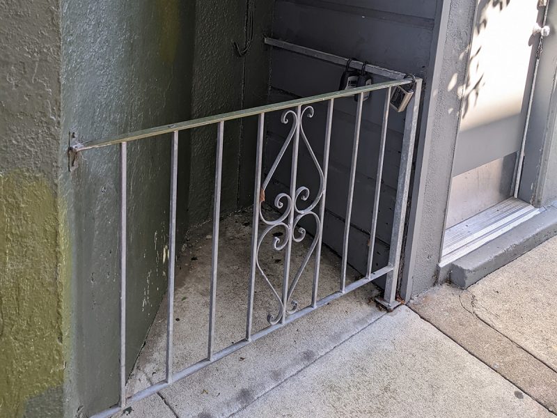 An outdoor gate at the corner of a building