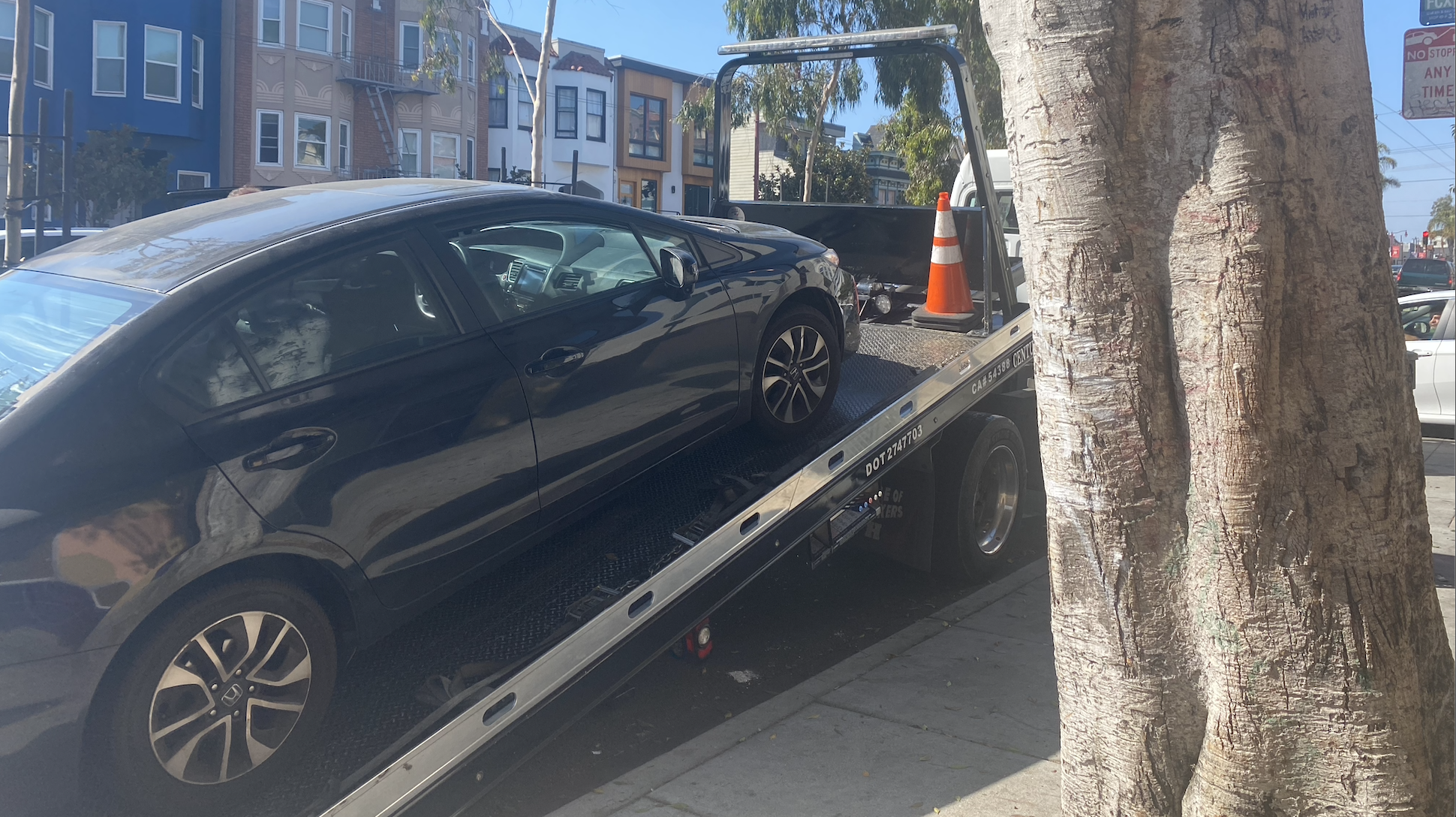 Car being towed away following collision at 24th Street and Potrero Ave.