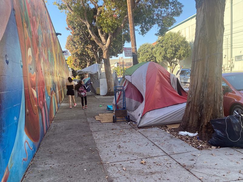A row of two or three tents along Harrison Street.