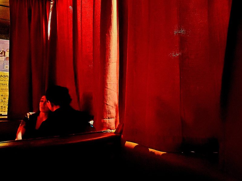 Two people in a dark bar.