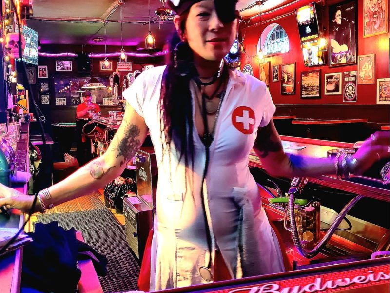 Someone in a nurse uniform at a bar
